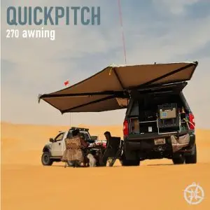 Two vehicles in a desert are shaded by 270 Single Hinge Awnings. Camping gear, chairs, and a table rest underneath. A faithful dog sits nearby as the words 270 Single Hinge Awning hover proudly above.