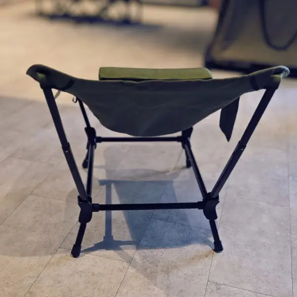 chicari chillax chair (1) The Chicari Chillax Chair, a green folding director’s chair with fabric seat and backrest, features a lightweight black frame for easy portability. Shown unoccupied on a tiled floor and viewed from behind.
