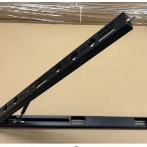 A Shower Swing Arm Bracket in black metal with an angled, perforated arm attached to a flat base is placed on a cardboard surface, designed for mounting or supporting shower equipment.